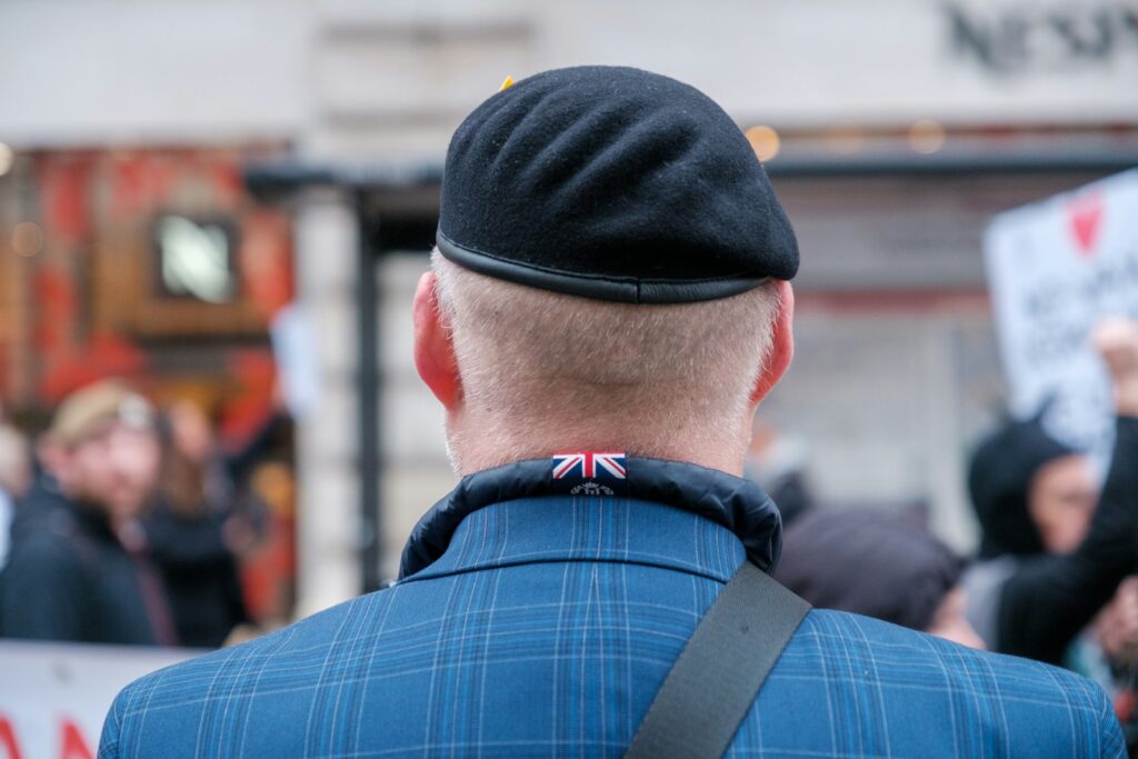 a man wearing a blue jacket and a black hat